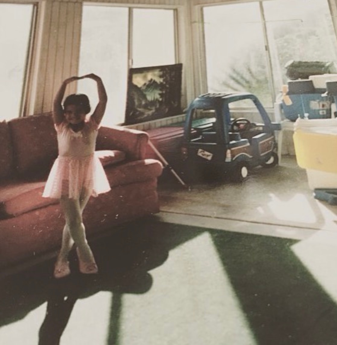Yvette as a child practicing ballet in her family living room